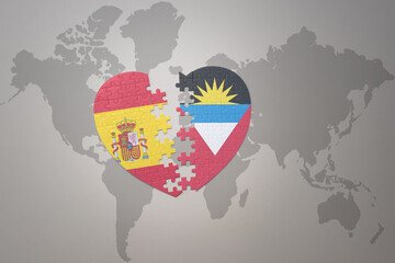 puzzle heart with the national flag of antigua and barbuda and spain on a world map background. Concept.