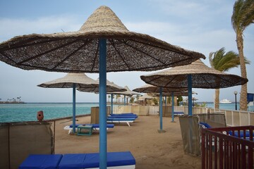 Umbrellas and sunbeds, on the beach of Arabia Azur resort, in Hurghada, Egypt.