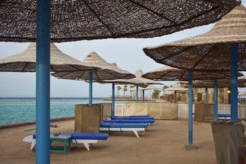 Umbrellas and sunbeds, on the beach of Arabia Azur resort, in Hurghada, Egypt.