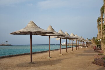 Row of umbrellas, on Arabia Azur beach resort, in Hurghada, Egypt.