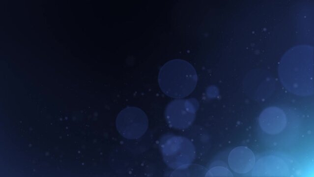 Elegant defocused blue dust particles over dark blue background loop