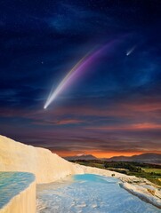 Fantastic unreal image: giant colorful comet in dark starry sky over white Pamukkale, Turkey © IgorZh