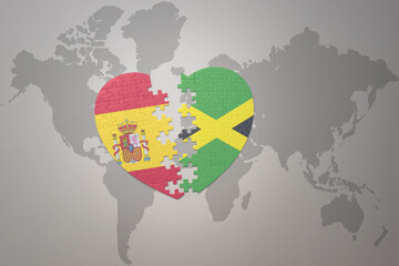 puzzle heart with the national flag of jamaica and spain on a world map background. Concept.