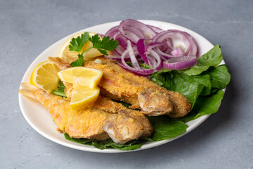 Plate of fried small fish red mullet and lemon