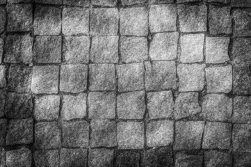 black and white square stone pattern with sun glare