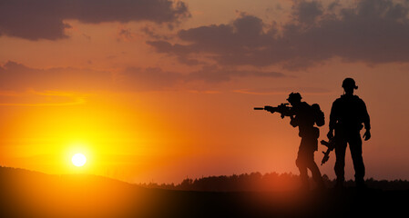 Fototapeta na wymiar Silhouettes of soldiers standing against the backdrop of a sunset. Greeting card for Veterans Day, Memorial Day, Independence Day. USA celebration. Concept - patriotism, protection, remember honor.