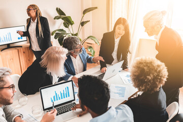 group of business people of different ages women and men in office working together - business concept -