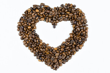 The heart is laid out with coffee beans on a gray (light) background.