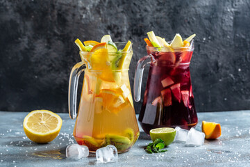 detox water two decanters for water with a cold refreshing drink of orange and berries, with ice...