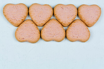 Heart shaped cookies on a gray concrete background. Space for the text. Recipe, ingredients. The concept of love and celebration. Birthday, Valentine's Day, good morning.
