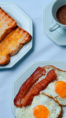 breakfast of champions: bacon, eggs, toast and coffe