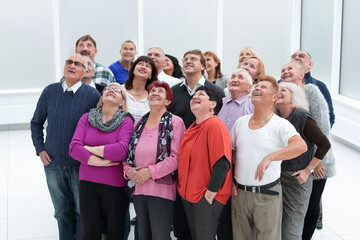 a group of older people look up