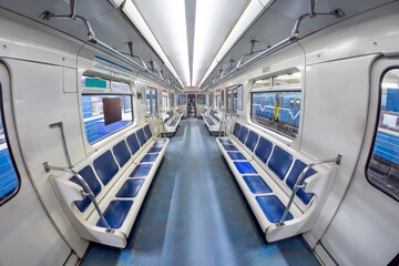 Modern subway metro train inside interior, empty public transport with blue seats. Wagon with open...