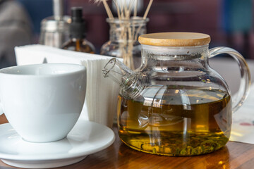 Close up of glass teapot with herbal tea.