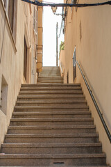 Fototapeta na wymiar Steps in narrow streets of Porto Cristo, Mallorca, Spain