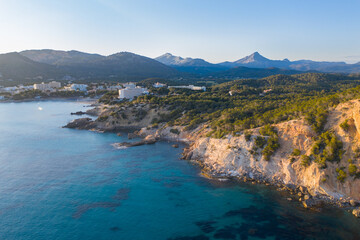 Aerial view of Peguera from sea side with hotels and beaches. Mountains in background. Mallorca, Balearic Islands, Spain