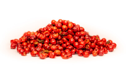 Pink peppercorns, spice close-up flat lay on a white background. Indian and Arabic spices for cooking. Medicinal herbs and spices.
