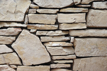 Close-up partial view of an old deteriorating stone wall