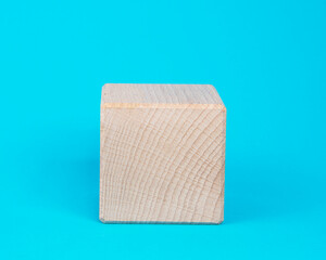 Empty clear wooden cube on blue background