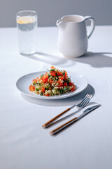 Vertical photo of Tabbouleh Vegetable Salad close-up, middle eastern national traditional food. Muslim family dinner, Ramadan, iftar. Arabian cuisine.