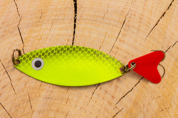 artificial metal baits on a wooden background. Homemade fishing gear. baits for catching large...