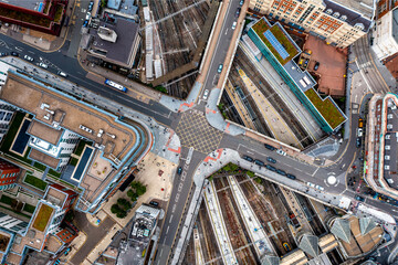Aerial top down view of a road and railway junction in city