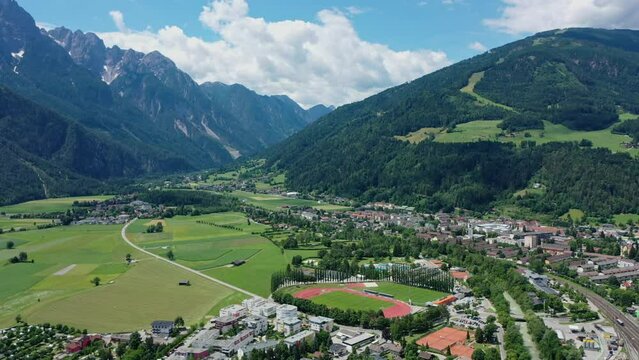 Beautiful mountain view in the city of Lienz, Austria. Alpine mountains, clouds and sunlight over the city. Aerial view over the Austrian city in the mountains Alps	
