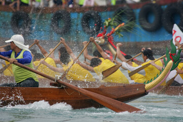 The helm steering the dragon boat in a race