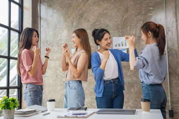 Happy excited successful asian women startup business team in office