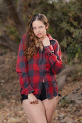 Beautiful woman in only a plaid shirt and short shorts