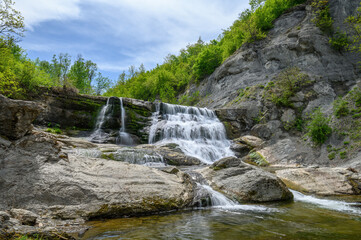 Obraz premium Hristovski Waterfall in Stara Planina mountain in Bulgaria in the area of the Ruhovtsi village on the river Miikovska. 