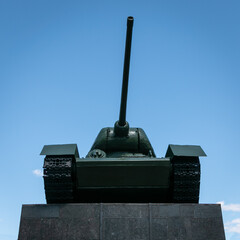 Minsk. Belarus. 05.23.2022. Soviet T-34 tank on a pedestal in Minsk against the blue sky. Symbol of...