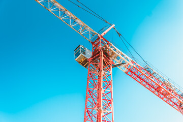 Construction crane against the blue sky. Construction of a new building. The concept of building a new area.