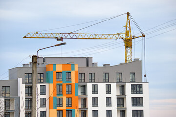 Tower cranes at high residential apartment buildings construction site. Real estate development