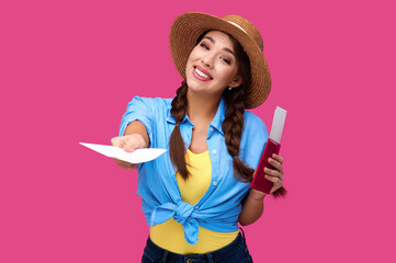Young smiling woman tourist with passport giving flight ticket. Caucasian traveler in summer casual clothes in pink isolated background. Female student with document - Powered by Adobe
