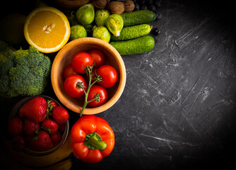 Different vegetables and fruits on an old background
