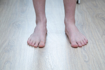 Underfloor heating in the apartment.A man is standing on a warm floor.