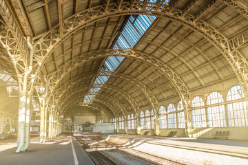 Architecture curved arches, metal struts and glass roof, interior details at empty train station