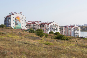 Fototapeta na wymiar Residential buildings on the shore of the Cossack Bay in the city of Sevastopol, Crimea