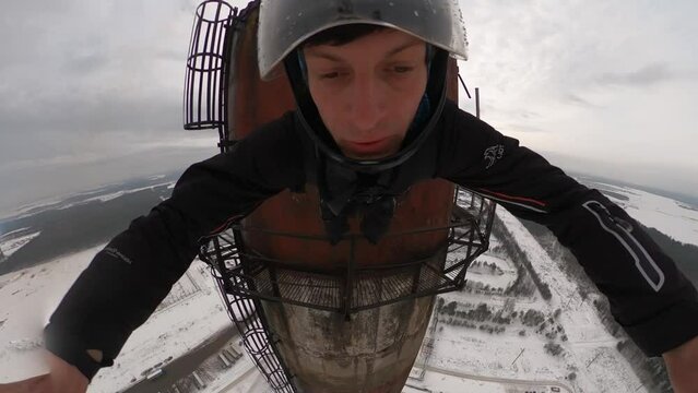 a man jumps from a 150-meter abandoned pipe with parachutes, extreme parachute jump, crazy stunt