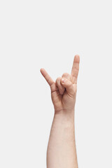 Child hand rock sign gesturing on white.