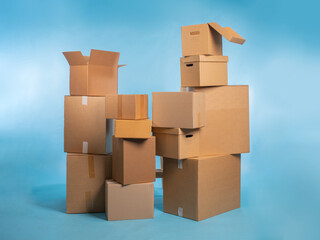 Cardboard boxes. Closed and open boxes. Concept - sale of corton containers. Packaging materials. Package for parcels on turquoise. Cardboard boxes of different sizes. Packaging for transportation