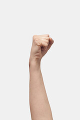 Close up female aggressive hand fist gesture on white.