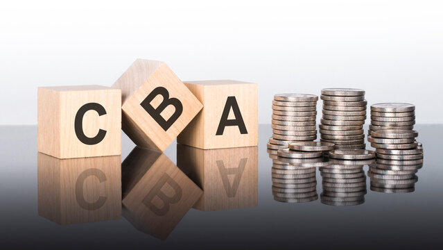 cba - text is made up of letters on wooden cubes lying on a mirror surface