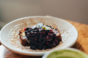 Sweet toast from homemade banana bread, non dairy yogurt and fresh berries compote