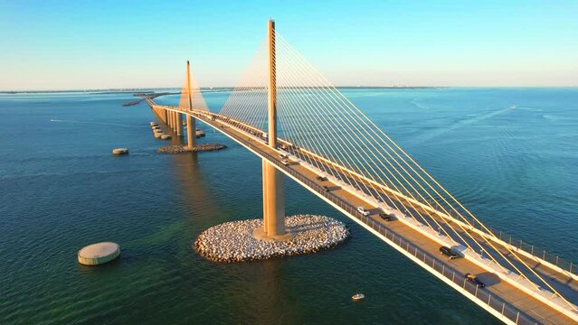 Sunshine Skyway Bridge spanning the Lower Tampa Bay and connecting Terra Ceia to St. Petersburg, Florida, USA. Day video. Ocean or Gulf of Mexico seascape. Reinforced concrete bridge structure.