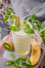 Kiwi milkshake in glass cup. garnished with mint