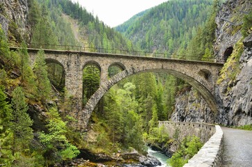 Fototapeta na wymiar Viaduct in Davos Monstein. Landwasser river flows through the canyon. hike along the river in the valley to filisur. Old