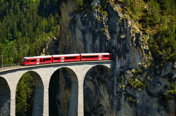 Railway bridge in Switzerland. Landwasser Viaduct in Graubunden near Davos Klosters Filisur. Railway company emblem.