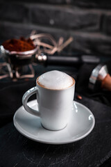 Presentation of bean coffee varieties with different types of cups on a special ground